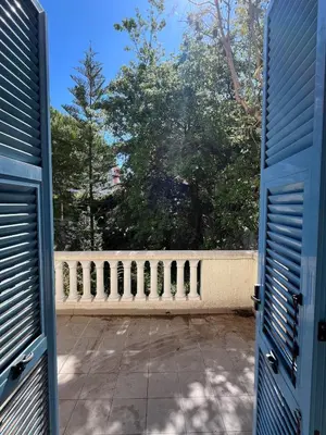 an open door to a balcony with trees at Seaside Jungle Retreat in Nice
