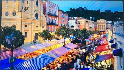a crowd of people walking around a market in a city at A Studio at Nice Beach in Nice