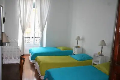a group of four beds in a room at Guest bedroom in private home, quiet, elegant, 10 mins to beach, 1 triple and 1 double bedrooms in Nice