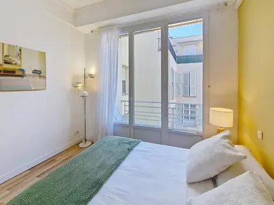 a bedroom with a bed and a large window at Nestor&Jeeves - CASA SOLANA - Terrace - Central in Nice