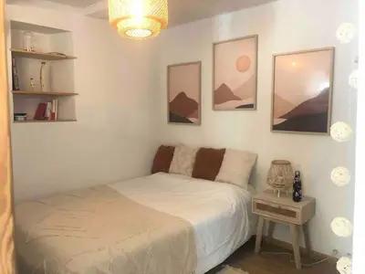 a small bedroom with a bed and a table at Cosy Studio Sea view in Villefranche-sur-Mer