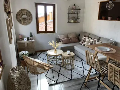 a living room with a couch and a table and chairs at Cosy Studio Sea view in Villefranche-sur-Mer