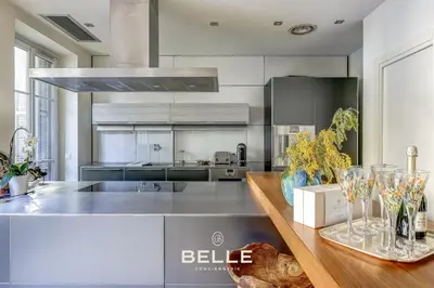 a kitchen with a counter with wine glasses on it at Le Rivoli Niçois - 180m2 - 3 Chambres in Nice