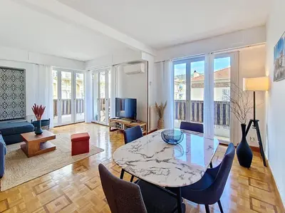 a living room with a table and chairs at Nestor&Jeeves - TROPI AZUR - Terrace - Place du Pin in Nice