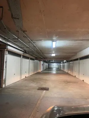 an empty parking garage with a car parked in it at Appartement rénové , Climatisé, Terrasse, Parking en sous sol in Saint-Laurent-du-Var