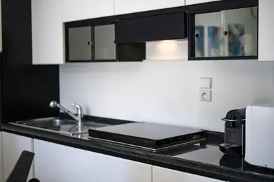 a kitchen counter with a sink and a microwave at Nice Fabron, terrasse & piscine dans résidence in Nice