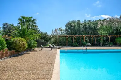 a swimming pool with two benches and a picnic table at Nice Fabron, terrasse & piscine dans résidence in Nice