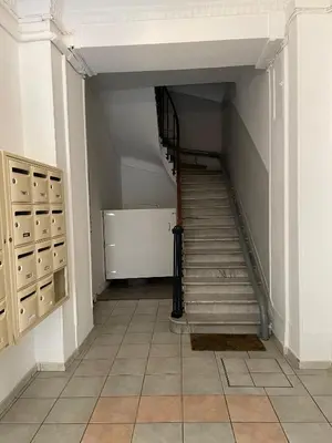 a hallway with a staircase in a building at Charming Riviera Top-Floor Apartment near the Beach in Nice