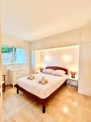 a bedroom with a large bed in a room at Golden Mornings, Sea, Garden, Breakfast & Free Parking in Villefranche-sur-Mer
