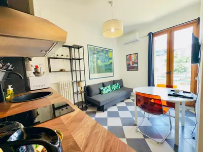 a kitchen and living room with a table and a couch at New Alba 3 Pers WiFi AC in Nice