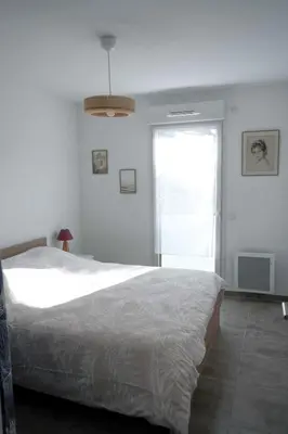 a bedroom with a large bed and a window at Sea view apartment close to beaches in Cagnes-sur-Mer