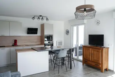 a kitchen with a counter and a table with chairs at Sea view apartment close to beaches in Cagnes-sur-Mer