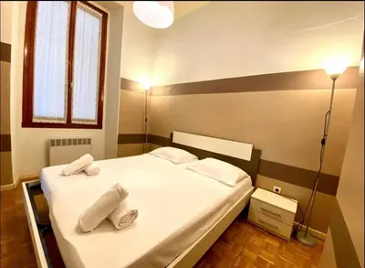 a bedroom with a bed with two towels on it at 2 pièces avec clim proche place Masséna in Nice