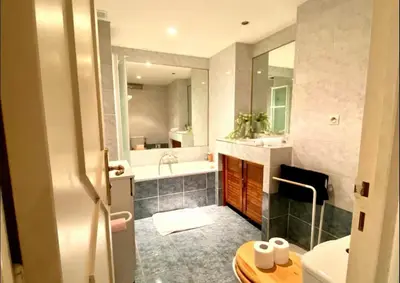 a bathroom with a tub and a sink and a toilet at 2 pièces avec clim proche place Masséna in Nice