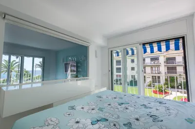 a bedroom with a bed and large windows at 3P ST Jean in Saint-Jean-Cap-Ferrat