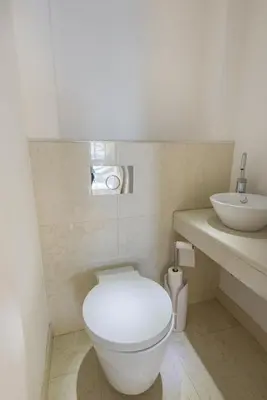a bathroom with a white toilet and a sink at 3P ST Jean in Saint-Jean-Cap-Ferrat