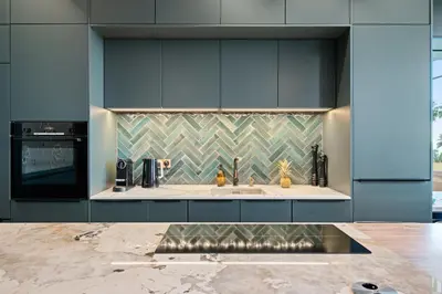 a kitchen with blue cabinets and a sink at La Fenêtre sur Mer - Superbe Vue Sur Le Port in Nice