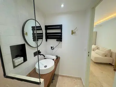 a bathroom with a sink and a mirror at ⁂ Studio Vieux-Nice climatisé: charme commodités in Nice