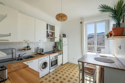 a kitchen with a sink and a dishwasher at 3 pieces lumineux avec balcon au coeur de la ville in Nice