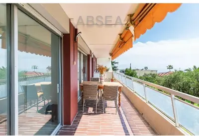 a balcony with a table and chairs and the ocean at Nice Absea Belles Terres 1' in Nice