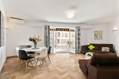 a living room with a table and a couch at Suite de Dijon FSHH in Nice