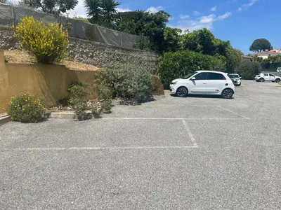 a white car parked in a parking lot at Chez Valentine in Nice