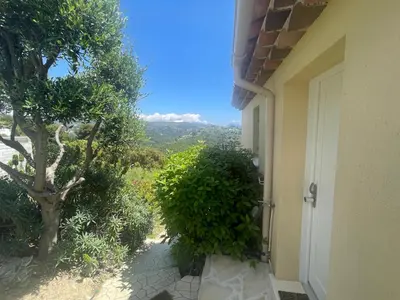 a door to a house with a view of a tree at Chez Valentine in Nice