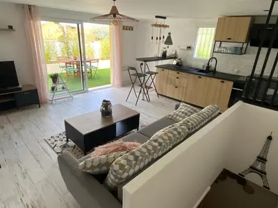 a living room with a couch and a kitchen at Chez Valentine in Nice
