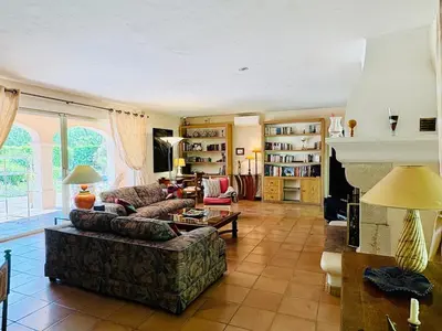 a living room with a couch and a table at Hacienda Provençale- Piscine, Pétanque et Plenitude in Saint-Jeannet