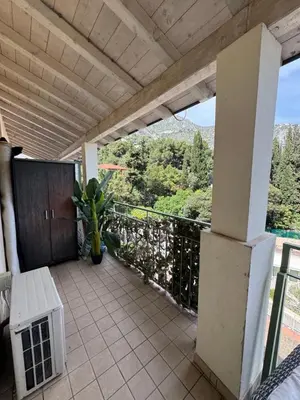 a balcony with a bench and a view of the mountains at Apartment duplex in Eze sur Mer in Èze
