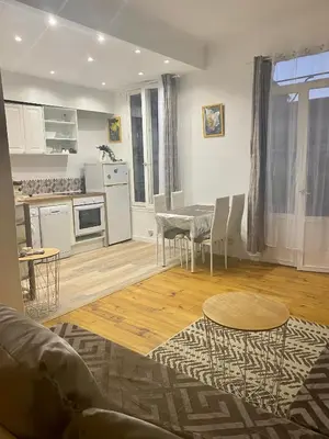 a kitchen and living room with a table and chairs at 3p proche Port in Nice