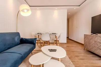 a living room with a blue couch and a table at Nice Appartement 4pers à 2 pas de la promenade in Nice