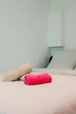 a bed with two red pillows on it at Nice Appartement 4pers à 2 pas de la promenade in Nice