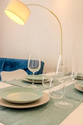 a table with wine glasses and a lamp on it at Nice Appartement 4pers à 2 pas de la promenade in Nice