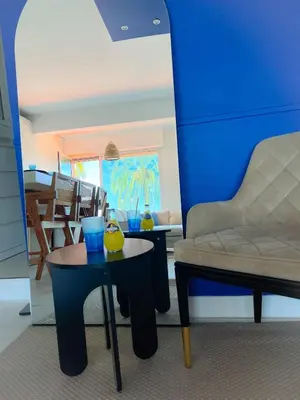 a living room with a couch and a table and a chair at Les pieds dans l eau in Nice