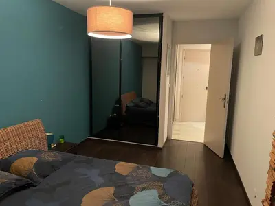 a bedroom with a bed and a room with a couch at Large 2-room bright sea view near airport in Nice