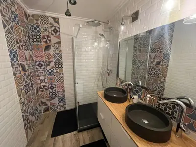 a bathroom with two sinks and a shower at Large 2-room bright sea view near airport in Nice