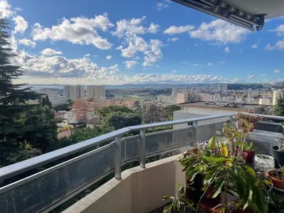 a view of a city from a balcony at Large 2-room bright sea view near airport in Nice