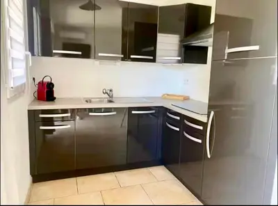 a kitchen with a sink and a refrigerator at DOMAINE LOU BEL AZUR - Paisible in Saint-Laurent-du-Var