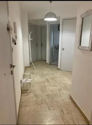 a bedroom with a large bed and a mirror at 3 pièces calme 5 mn Port in Nice