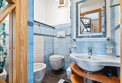 a bathroom with a sink and a toilet and a mirror at Vue Mer Prestige in Villefranche-sur-Mer