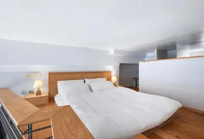 a bedroom with a large bed with white sheets at Vue Mer Prestige in Villefranche-sur-Mer