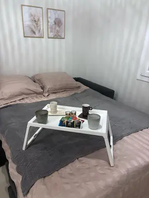 a white table sitting on top of a bed at Studio cosy Le Vismara in Nice