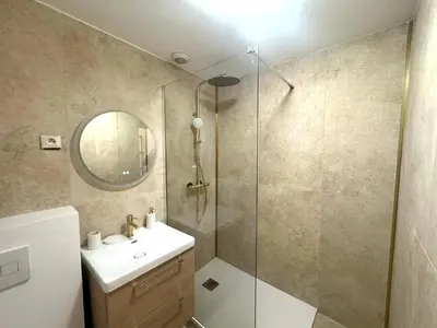 a bathroom with a shower and a sink and a mirror at Studio vieux nice coulee verte in Nice