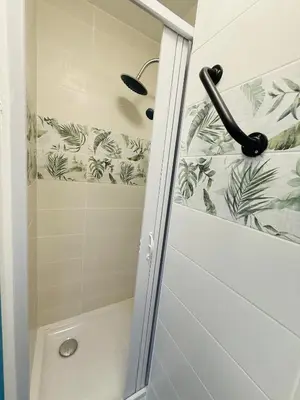 a shower with a glass door in a bathroom at Sweethome Massena in Nice