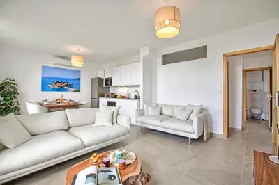 a living room with two white couches and a kitchen at Modern Apartment With City View - Happy Rentals in Nice