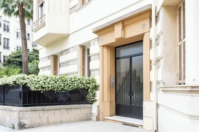 a building with a window with plants on it at Charmant appartement avec terrasse en plein cœur de Nice à deux pas de la mer ! in Nice