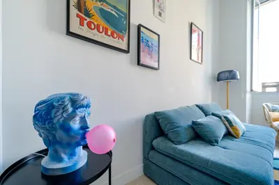a living room with a bust on a table with a couch at Loft hyper-centre de Nice in Nice
