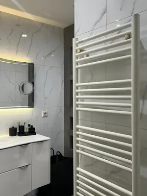 a kitchen with white walls and a glass refrigerator at Magnifique appartement - Vue mer in Nice