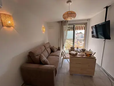 a living room with a couch and a table at Appartement cosy à 200 m de la mer in Cagnes-sur-Mer